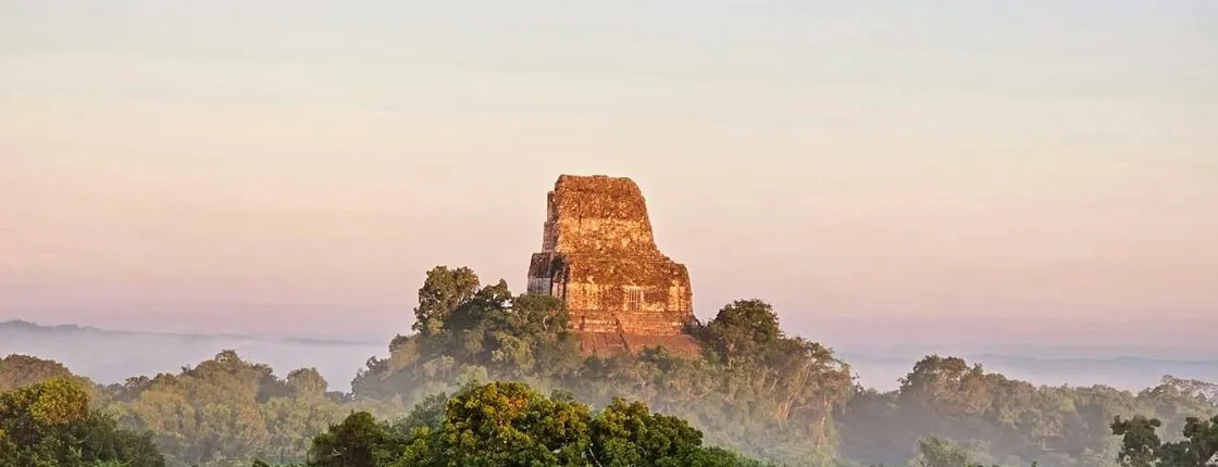 Explore ancient Maya temples on this Tikal sunset tour